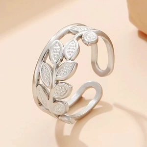Macro shot of silver titanium steel leaf ring with detailed granular textures and open band