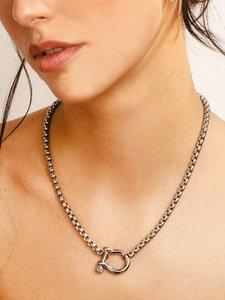 Close-up of industrial box chain necklace with a shackle clasp in silver finish