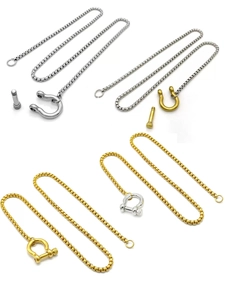 Detail view of 18k gold and silver stainless steel box chain with U-shackle clasp design