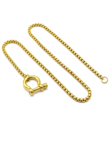 Detail of 18k gold plated stainless steel box chain with a U-shaped shackle clasp