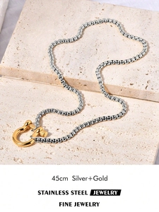 Detail of 18k gold plated horseshoe pendant on stainless steel silver box chain, 45cm long