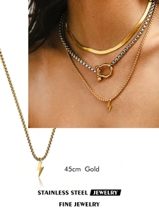 Detail of 45cm gold lightning bolt pendant on stainless steel chain for layering