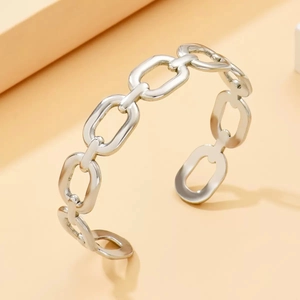 Detailed view of silver chain link open bangle in polished stainless steel finish