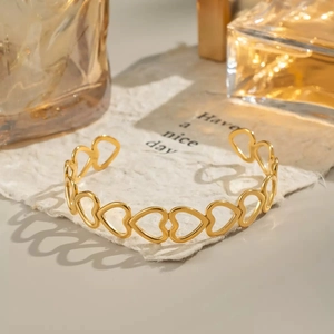 Detail shot of hollow heart pattern adjustable gold plated stainless steel bracelet
