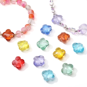 Macro shot of colorful glass flower beads for DIY jewelry making and handmade bracelets