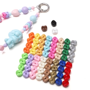 Macro shot of 9mm painted acrylic gear beads and DIY keychain with blue poodle charm