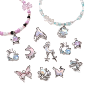 Macro shot of colorful DIY alloy pendants featuring stars, butterflies and dolphins