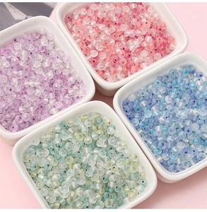 Macro detail of translucent pastel chameleon glass beads in square sorting trays