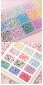 Close-up of colorful translucent glass seed beads in a multi-grid storage organizer box