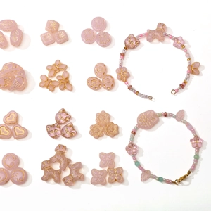 Pink DIY jewelry kit with cat, heart and floral beads for handmade bracelets