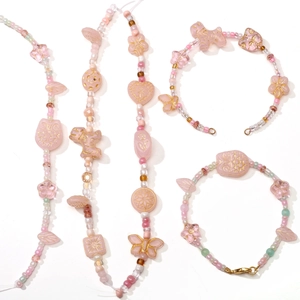 Pink handmade DIY jewelry kit with Czech glass leaf beads and donut charms for necklaces