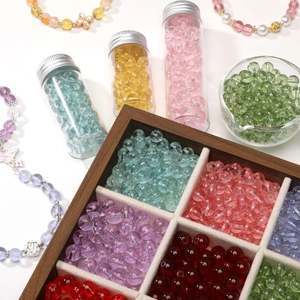 Colorful translucent glass beads set in a wooden box for DIY jewelry making
