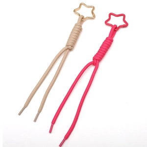 Braided paracord keychain accessories in pink and beige with star-shaped metal clasps