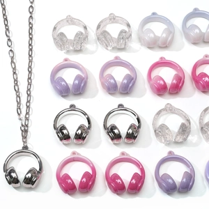Close-up of mini headphone charms in gradient resin and silver plating for DIY jewelry