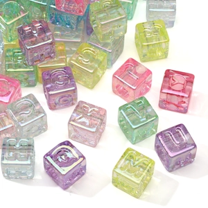Macro shot of colorful iridescent 12mm acrylic letter beads for DIY jewelry making projects