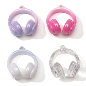 Close-up of DIY acrylic headphone charms in gradient purple, pink, blue and glitter finish
