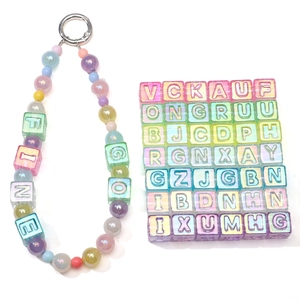 Close-up of 12mm translucent colorful acrylic square letter beads for DIY jewelry making