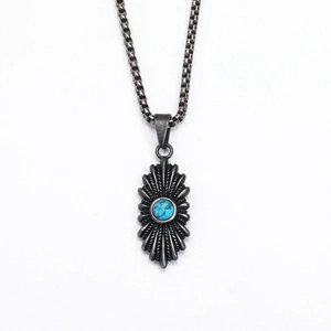 Detailed shot of retro sunburst pendant with turquoise inlay and black box chain