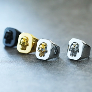 Punk style stainless steel skull rings for men in black, gold, and silver finishes
