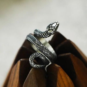 Detailed view of the lifelike snake scale texture on a coiled titanium steel serpent ring
