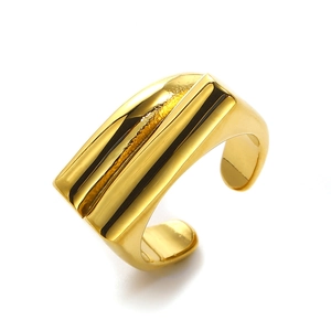 Detailed view of wide irregular geometric gold ring with polished 18k finish
