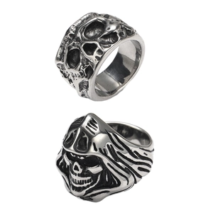 Detailed close-up of retro punk skull and reaper rings in vintage steel finish
