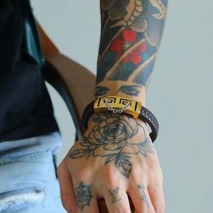 Ethnic braided leather bracelet for men with golden meander buckle and silver chain