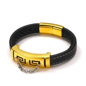 Detail of men's woven leather bracelet with golden hollow metal plate and silver chain link