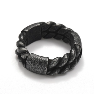 Macro shot of industrial punk titanium steel ring with rope texture and oxidized finish
