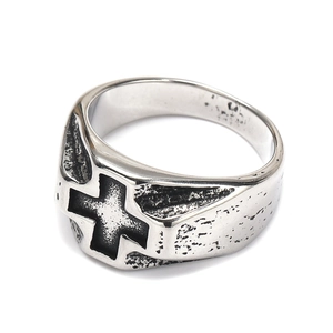Macro detail of retro cross engraving on silver titanium steel ring with gothic finish