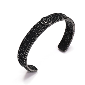 Macro detail of Viking cuff bracelet featuring Valknut symbol and antique Rune engravings