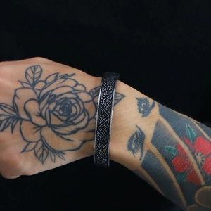 Macro shot of Viking vintage geometric pattern on an oxidized steel open cuff bracelet