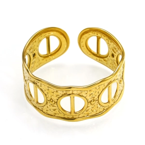 Detail of 18k gold hollow cuff bracelet featuring hammered texture and wave edges