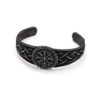 Close-up of vintage steel Viking Vegvisir cuff bracelet with Nordic rune engravings
