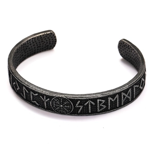 Detailed engraving of Viking compass Vegvisir and Runes on vintage steel cuff