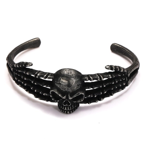 Detail of vintage Viking skull bracelet with skeletal bone design in oxidized steel finish