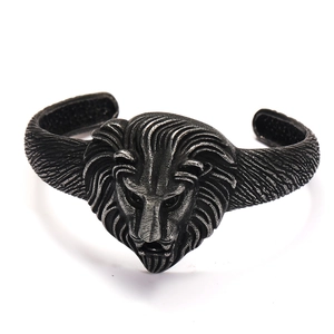 Close-up of vintage lion head cuff bracelet with oxidized silver finish and carvings