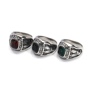 Detail of vintage eagle rings with emerald, ruby, and onyx stones in high school style