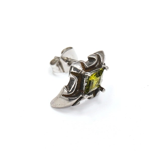 Close-up of vintage silver cross earring with square green zircon and butterfly back