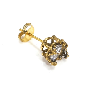 Detailed macro view of vintage gold crown stud earring with clear faceted zircon stone