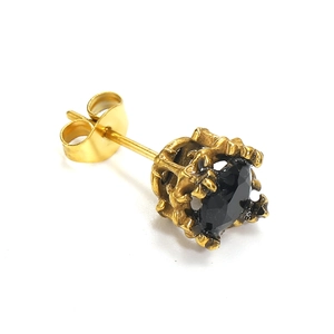 Macro shot of vintage gold crown-set earrings featuring a faceted black zircon stone