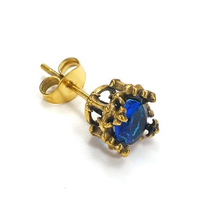 Macro view of blue crystal stud earring with golden crown bezel and butterfly back