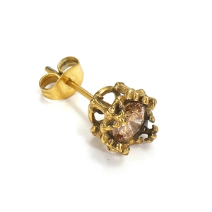 Detailed macro view of vintage gold crown setting stud earring with clear zircon