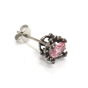 Detail view of pink oval zircon stud earring in a vintage oxidized claw setting