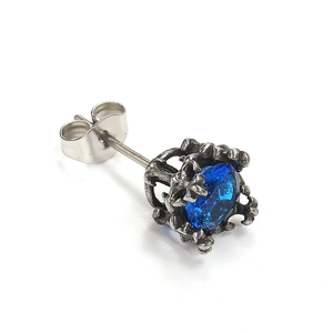 Macro shot of vintage style titanium steel stud earring with blue zircon stone detail