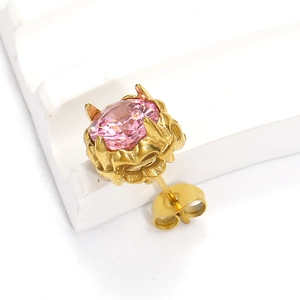Vue détaillée d'une boucle d'oreille vintage dorée avec un grand zircon rose rond