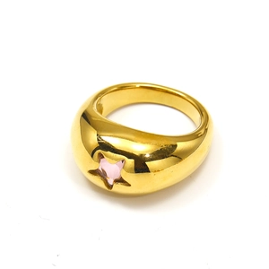 Close-up of a chunky 18k gold plated ring featuring a polished pink star centerpiece