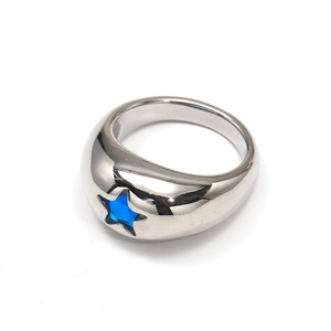 Detailed view of silver titanium steel ring with a polished blue star crystal inlay