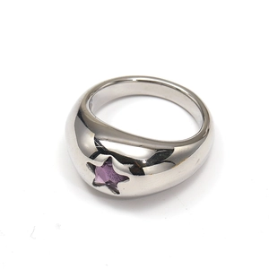 Macro detail of silver titanium steel ring with purple star-shaped gemstone inlay