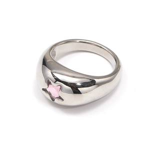 Detailed macro of silver domed ring featuring a pink star-shaped zirconia inlay